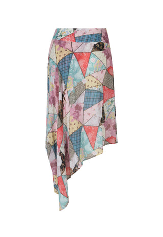 an-asymmetrical-wrap-skirt-featuring-a-colorful-patchwork-print-of-geometric-triangles-and-floral-patterns-in-pink-blue-beige-and-purple-shown-against-a-plain-white-background