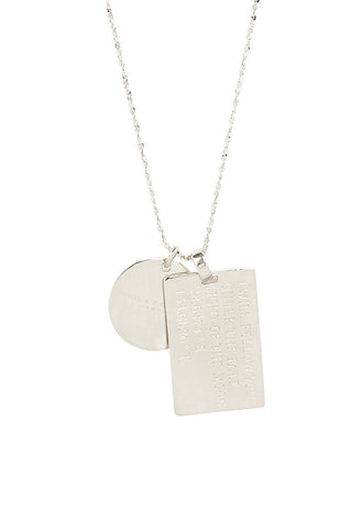close-up-back-view-of-spell-s-aries-stargazer-zodiac-necklace-charms-one-charm-is-of-a-rectangular-shape-and-an-inspirational-quote-while-the-other-charm-is-circular-the-brand-name